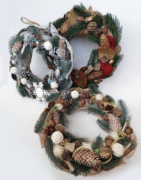 Christmas Wreath of pine branches, cones, leaves, beads and snowflakes. Holiday Decoration Gift For family and friends. New Year's home wall decor different angles handmade top view, side view - Photo, Image