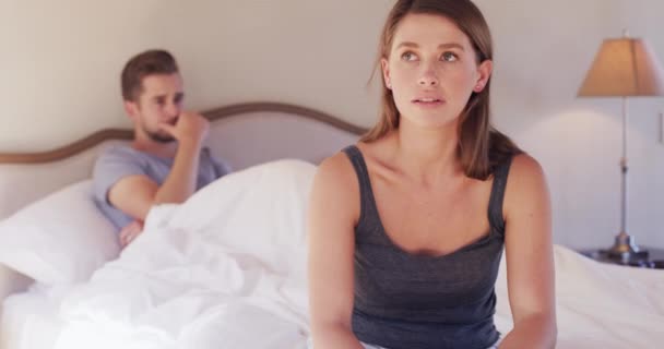 Couple, stress and sad on bed with fight, erectile dysfunction or anger with affair, bad news or divorce. Woman, man and frustrated with conflict, marriage or cheating in morning, home and bedroom. - Footage, Video