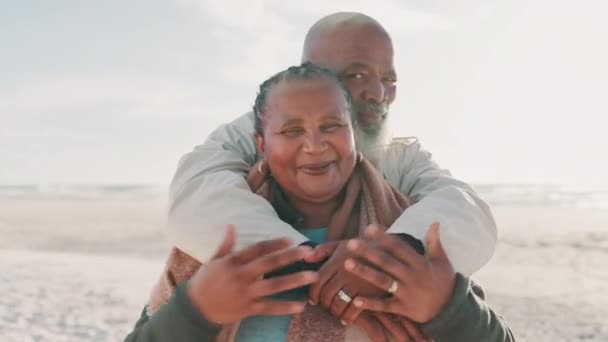 Senior, couple and hug on beach with love for vacation, holiday or adventure with romance and freedom. Black people, man or woman by sea or ocean and happy for experience, embrace or travel for fun. - Footage, Video