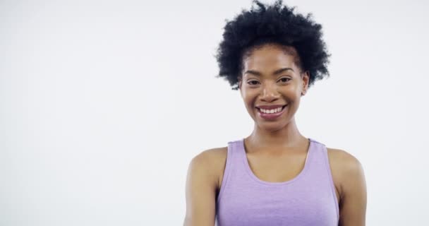 Woman, thumbs up and face in studio for exercise, health and excited for agreement by white background. Happy African girl, emoji and yes icon with sign language, review and feedback for fitness. - Footage, Video