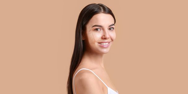 Portrait of beautiful woman with dry and healthy skin on beige background - Photo, Image