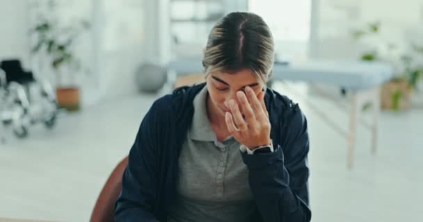 Face, woman and headache for stress with job, career or occupation in physiotherapy. Female doctor, alone and suffering from burnout, mistake or migraine with mental health for overtime in office. - Footage, Video