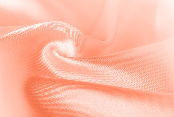 Color of the year 2024 Peach Fuzz 13-1023. Peach fuzz color silk texture, background. Color of the year 2024 for design, text mockup, cards, luxury concept. - Photo, Image