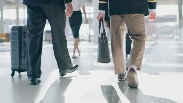 Luggage, airport lobby and pilot walking with bag for flight, schedule or international transportation job. Men, suitcase and team together for global travel, airplane and ready to start working. - Footage, Video