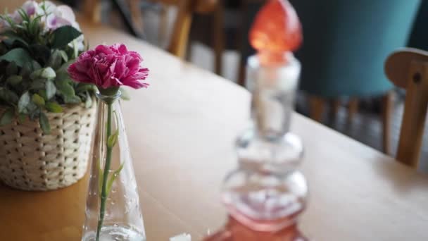 rozmyte tło kawiarni z kwiatem na stole - Materiał filmowy, wideo