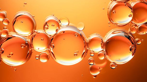 Kosmetische Öltropfen mit Luftblasen auf einem goldenen Hintergrund. Textur eines kosmetischen Produkts. - Foto, Bild