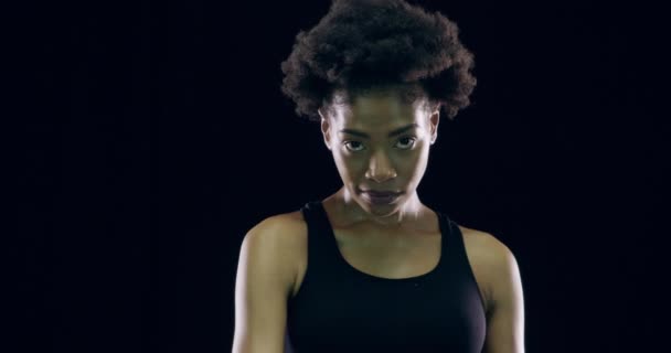 Face, pointing to you and black woman with fitness, motivation and kick boxing on a dark studio background. Portrait, African person and model with exercise, funny and boxer with challenge or workout. - Footage, Video