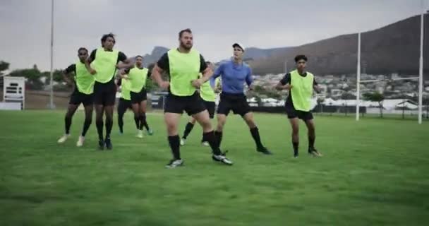 Rugby, training and coach with men running for exercise and warm up for practice, match or game. Fitness, teamwork and trainer with players workout for wellness, performance or cardio on sports field. - Záběry, video
