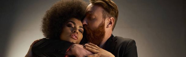 γενειοφόρος άντρας φιλάει αφροαμερικανή γυναίκα με σγουρά μαλλιά, οικεία στιγμή σέξι λάβαρο ζευγάρι - Φωτογραφία, εικόνα