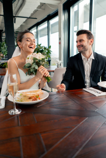 portrait of smiling bride and groom in love newlyweds wedding in restaurant during celebration of love romance - Photo, Image
