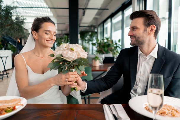 portrait of smiling bride and groom in love newlyweds wedding in restaurant during celebration of love romance - Photo, Image