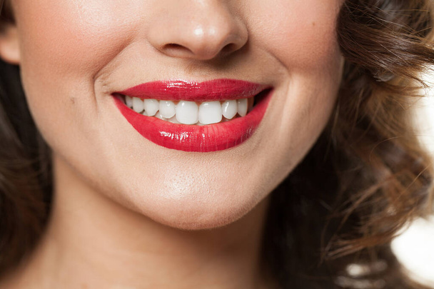 Güzel bir kadın gülüşü, beyaz dişleri ve kırmızı dudakları var. Güzellik portresini yakından çek. - Fotoğraf, Görsel
