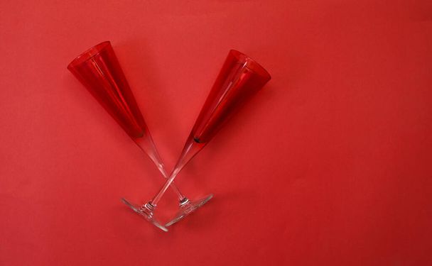 Two red color glasses on red banner - romance and love concept. - Photo, Image