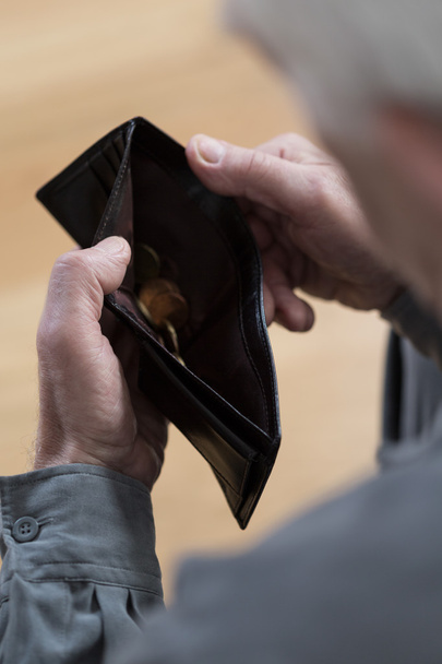 Senior man holding empty wallet - Fotó, kép