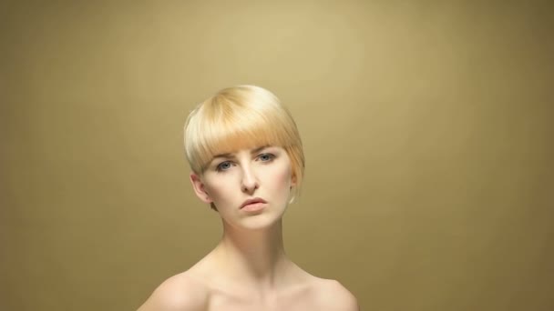 Krótkie blond włosy kobieta pozowanie do kamery - Materiał filmowy, wideo
