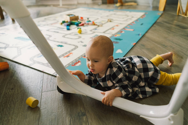 Cute baby girl playing with a toy on a play mat. Baby development. - Photo, Image