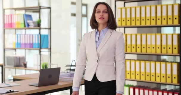 Portrait of successful confident beautiful business woman. Portrait of real estate agent standing in modern office looking at camera and smiling friendly - Footage, Video