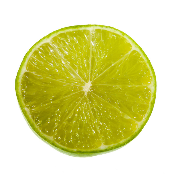 Green lime with cut in half isolated on white background. - Photo, Image