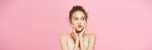 Close up face of beautiful woman posing isolated on pink color background - Photo, Image