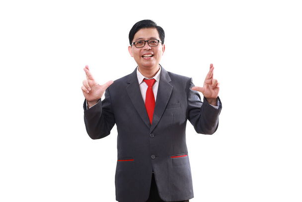 Lächelnder asiatischer Geschäftsmann, der die Daumen drückt. Isoliert auf Weiß - Foto, Bild
