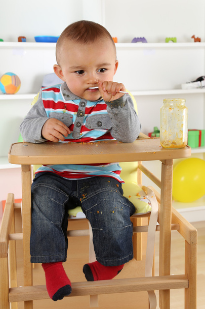 Child eating baby food from glass - Zdjęcie, obraz