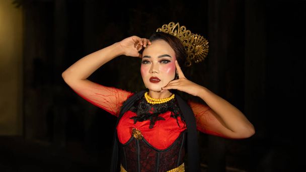An Indonesian dancer becomes an ambassador of cultural beauty and elegance by dancing on stage at night - Photo, Image