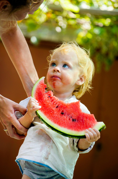 Infant baby with a melon - Fotó, kép
