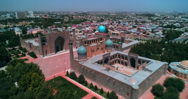 Egy drón repül át egy ősi Bibi Khanym mecset felett. Napfényes nyári nap. Szamarkand, Üzbegisztán. Légitekintés. - Felvétel, videó