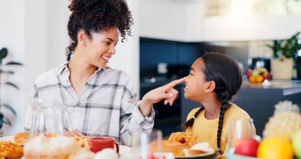 Smile, breakfast and mother eating with child in dining room at modern home together for bonding. Happy, love and young mom enjoying healthy morning food and juice with girl kid at family house - Photo, Image