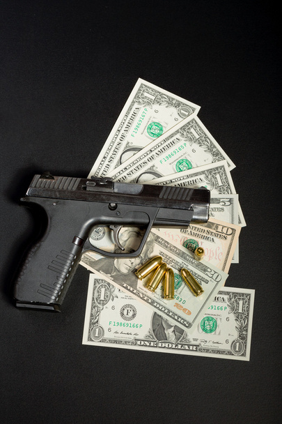 gun with bullet on US dollar banknotes - Φωτογραφία, εικόνα
