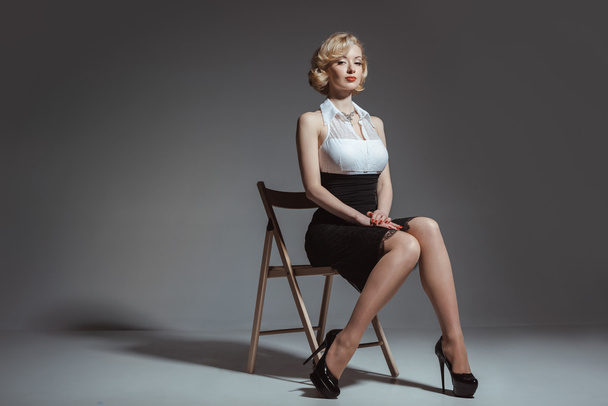Pin-up girl young and beautiful woman portrait on gray background - Fotó, kép