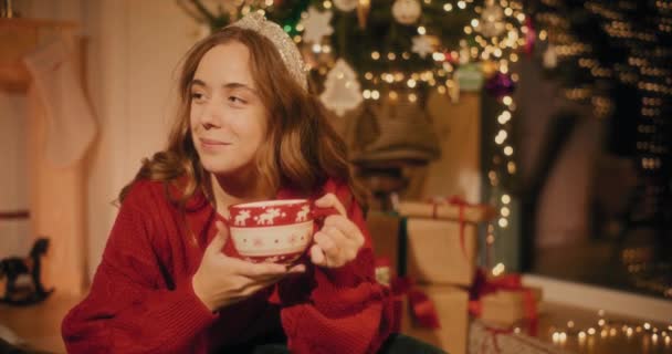 Woman talking with male friend while having coffee sitting at home during Christmas - Footage, Video