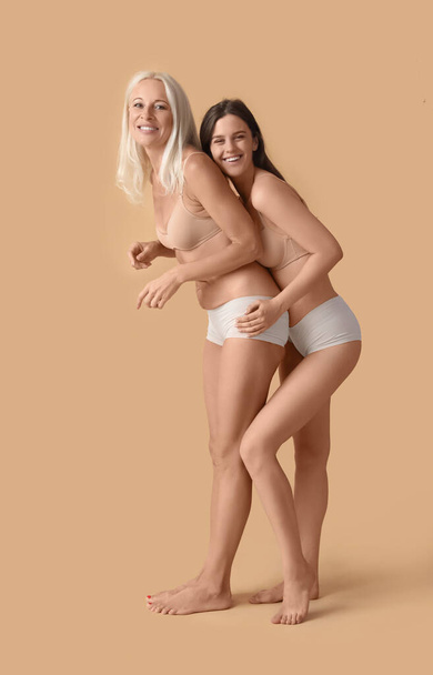 Body positive women in underwear on beige background - Photo, Image