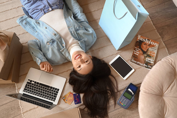 Jonge Aziatische vrouw winkelen online thuis, top view - Foto, afbeelding