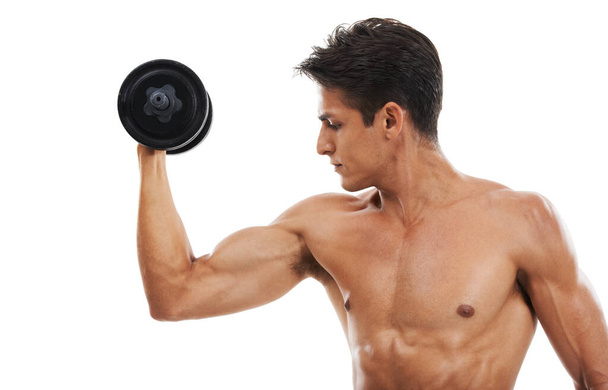 Man, dumbbell and workout in studio for fitness, wellness and healthy body with exercise or training. Person, athlete or physical activity for muscles, bicep and shirtless on white background for abs. - Photo, Image