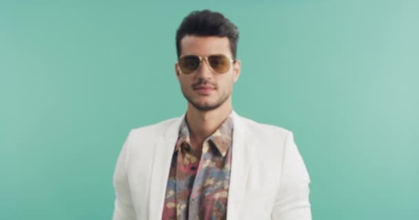 Man, face and 80s fashion with sunglasses in studio, chic and stylish with mockup space on green background. Model with vintage style, eyewear or shades, beauty and cosmetics with fashionable clothes. - Footage, Video