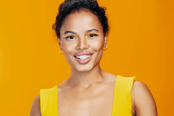 Donna bello studio colorato giallo modello nero make-up spazio sorriso stile copia creativo cosmetica moda cosmetologia pelle bellezza viso ritratto africano - Foto, immagini