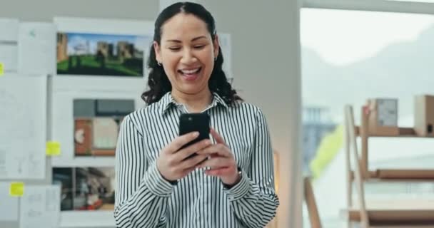 Woman, smile and walking with phone in office for social network, mobile chat and business contact. Happy employee scroll on smartphone, reading notification and search news on digital app in agency. - Footage, Video