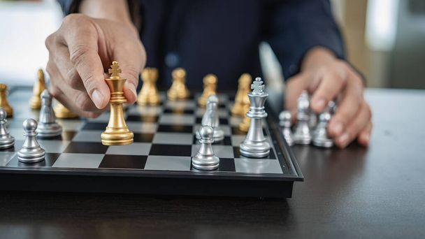 Businessman is playing chess game, leading strategy planning, business leader concept and thinking of strategy plan about toppling the opposing team and analyzing the development for success. - Photo, Image