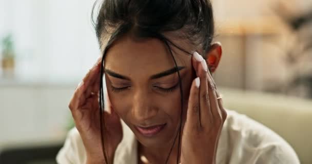 Face, woman and pain in home for headache, anxiety and frustrated for mental health, fatigue and breathe for brain fog. Tired indian girl massage temple for depression, burnout and stress of vertigo. - Filmati, video