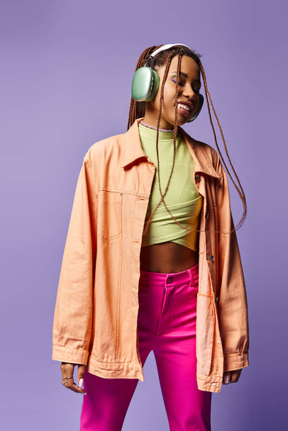 smiling african american girl in 20s listening music in wireless headphones moving to rhythm, dance - Fotó, kép