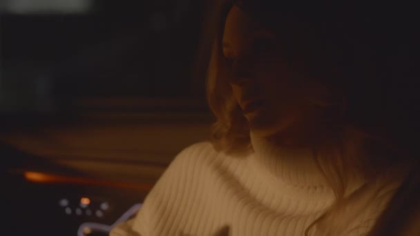 Detailní záběr zasněné zamyšlené ženské tváře, krásná dáma sedící v autě, světelné záblesky z projíždějících aut venku, noční scéna. Být sám, čekat a snít. Vysoce kvalitní 4K záběry - Záběry, video