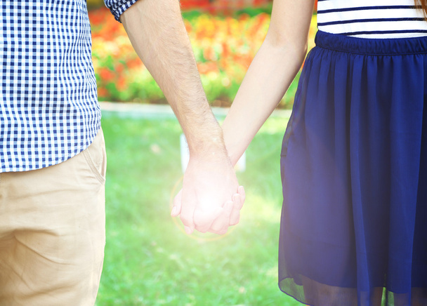 Loving couple holding hands outdoors - Photo, Image