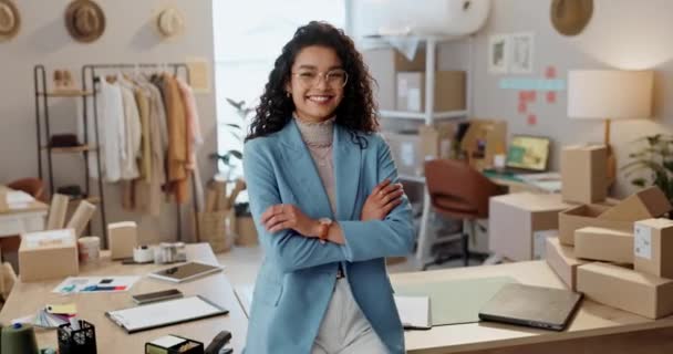 Designer woman, arms crossed and smile at workshop, pride or entrepreneurship by boxes for e commerce. Small business owner, clothes and package for shipping, supply chain and face at fashion startup. - Footage, Video