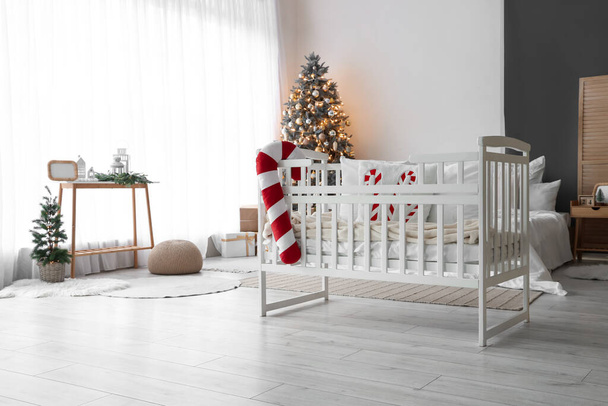 Baby crib with candy cane pillow in bedroom interior - Photo, Image