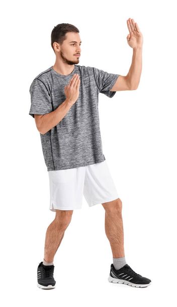 Young man training on white background. Concept of self defense - Foto, immagini