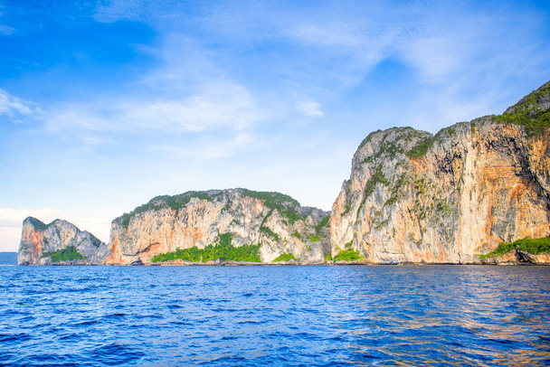 Hermoso paisaje al atardecer de la Bahía Maya en las Islas Phi Phi en Tailandia - uno de los lugares más famosos con vistas al paraíso, playa de arena y rocas verdes  - Foto, Imagen
