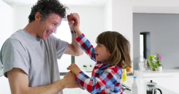 Family, happy play and kid in kitchen with dad and smile with game and bonding with care. Home, father and child together with love parent and support conversation in a house with morning fight. - Footage, Video