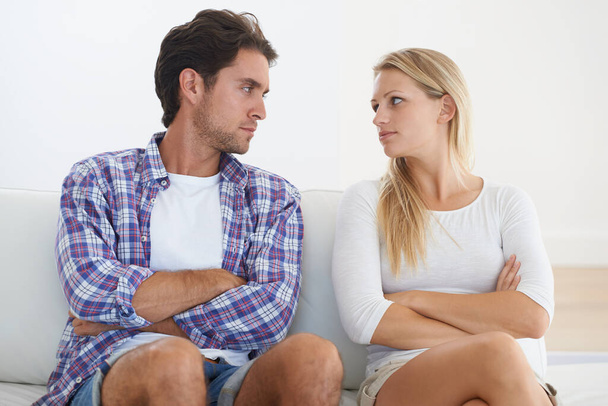 Couple, angry and living room couch with disagreement, upset and staring with anger, fight or mad. Divorce, betrayal and relationship with cheating, stress and argument for marriage, home or toxic. - Photo, Image