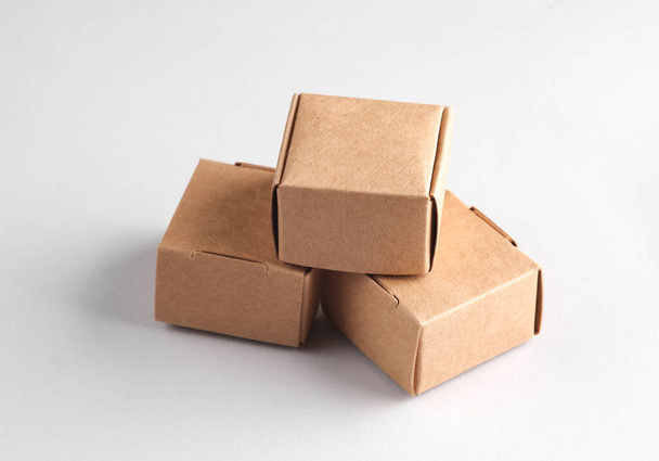 Parcel cardboard craft boxes on a gray background - Photo, Image